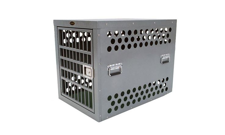 Picture consisting of a metal carrier specifically designed for carrying potentially dangerous breeds. This container, called CR82, is all metal and is lying on a white surface.